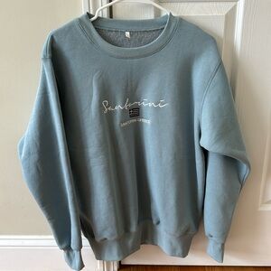 Santorini, Greece foam green pullover sweatshirt.